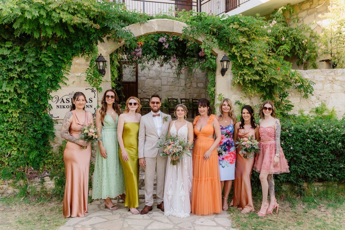 Wedding party under a garden archway