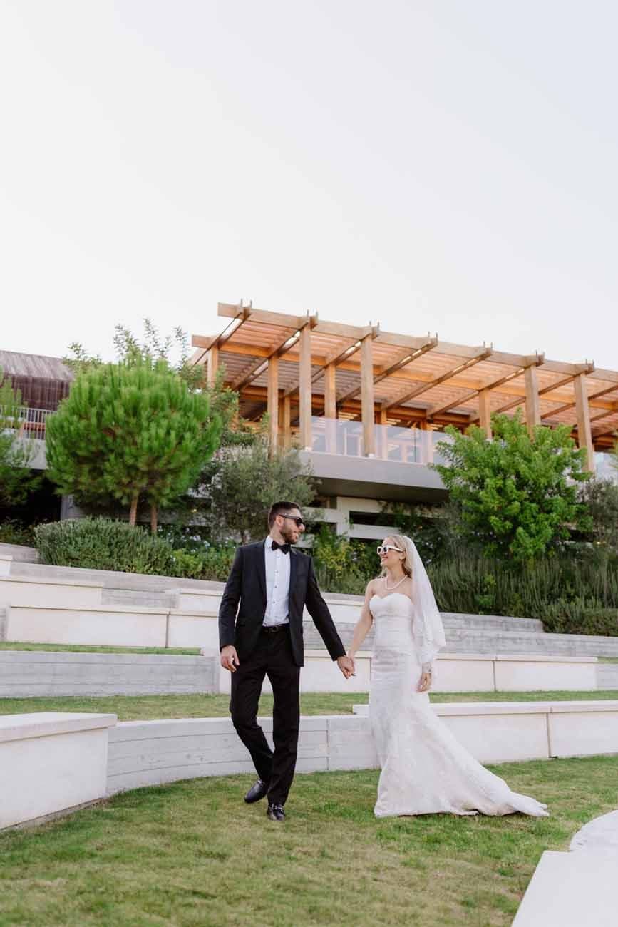 Newlyweds dancing outdoors at night between fountains of sparks