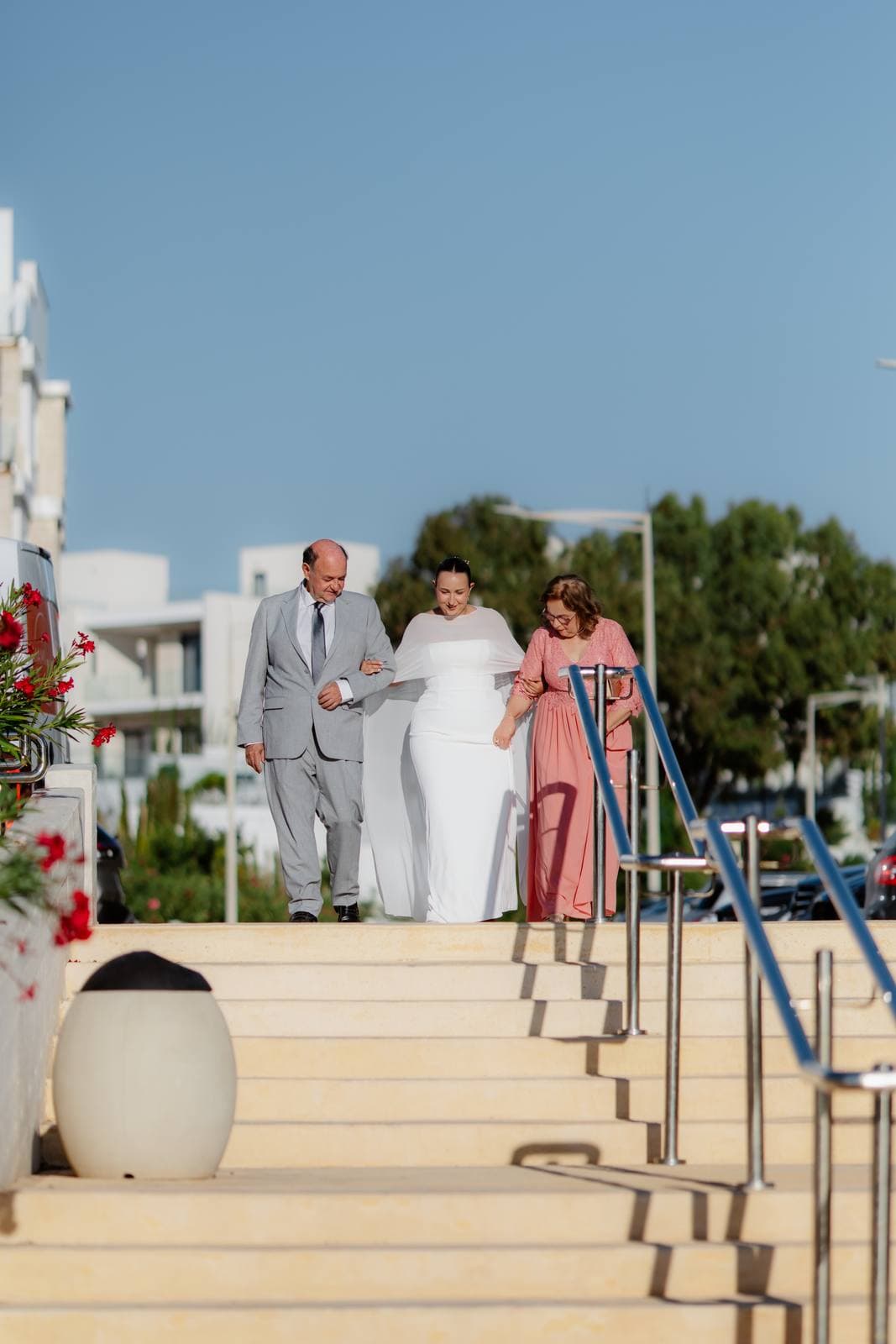 Christos & Eleni, the bride walking down to the chapel with her parents