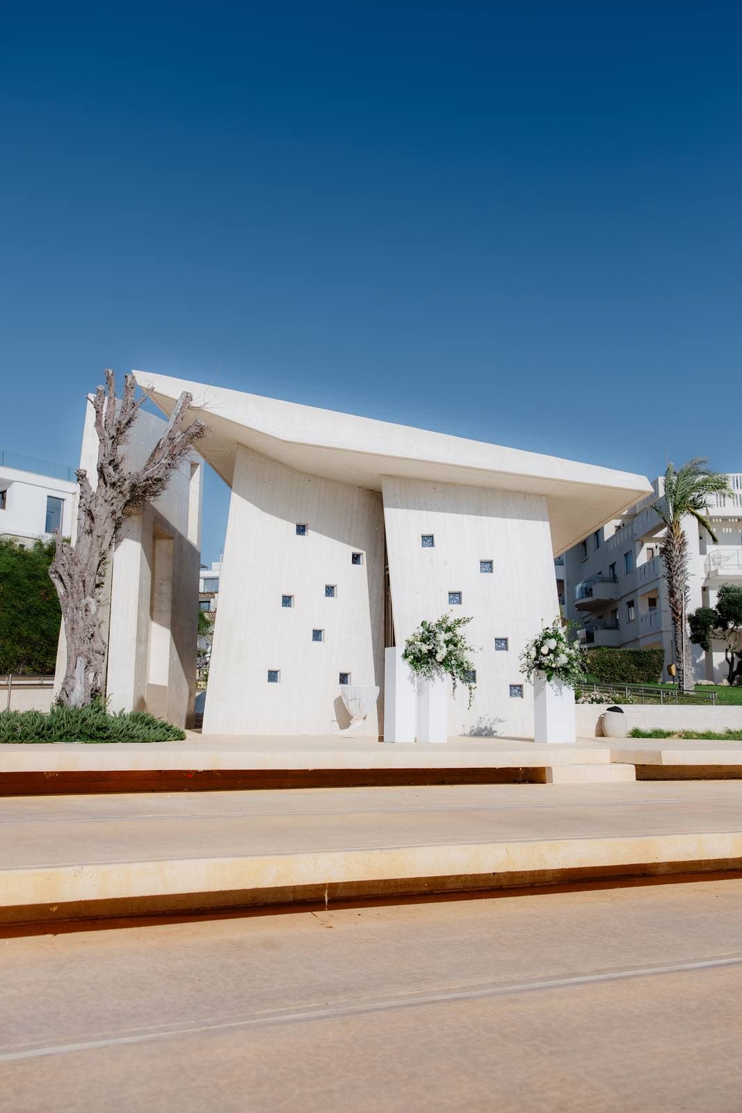 Christos & Eleni, the white chapel of Ayia Thalassini under a blue sky