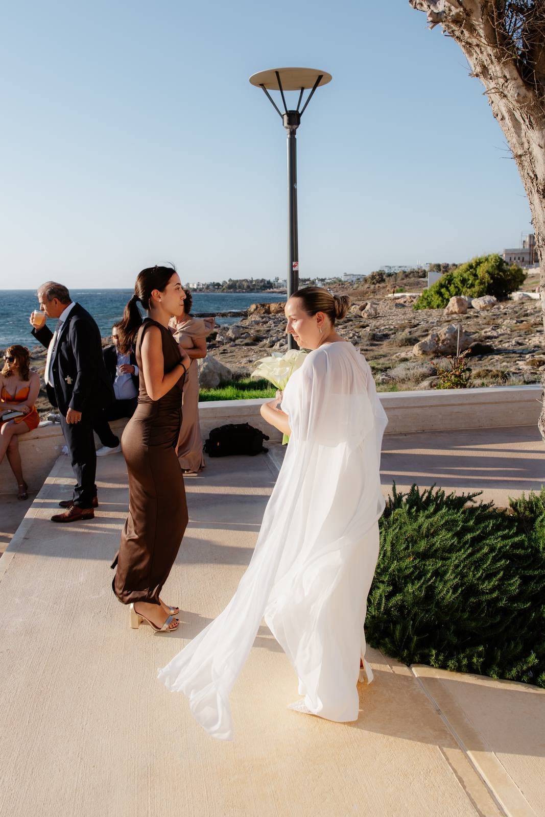 Christos & Eleni, the bride's cape in the sea breeze