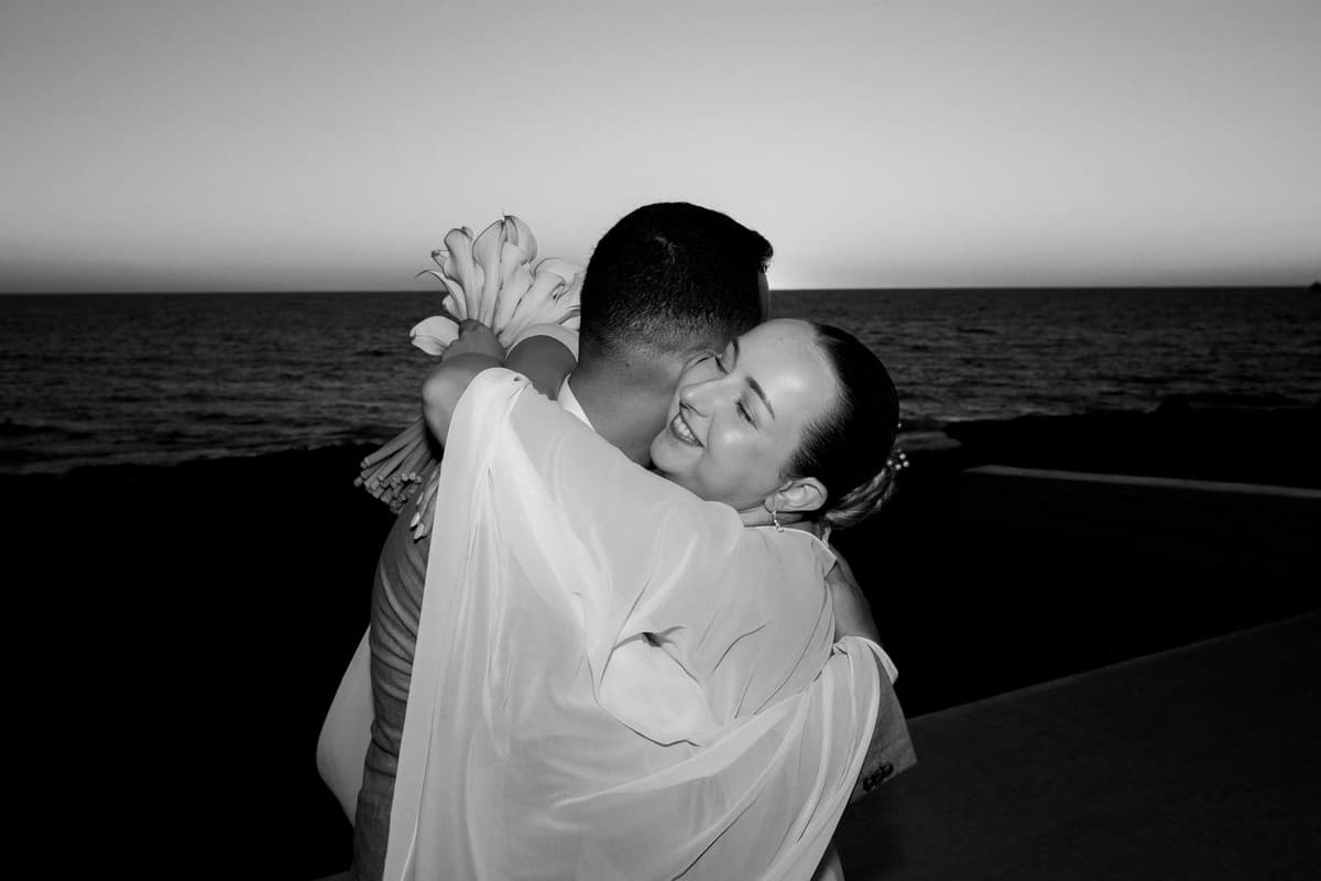 Christos & Eleni, a hug at sunset, in black and white