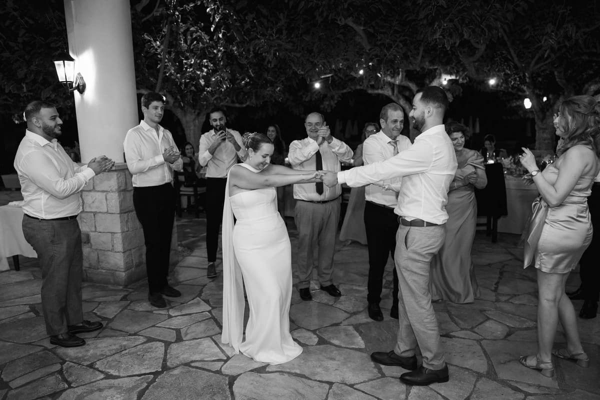 Christos & Eleni, dancing in a circle, in black and white