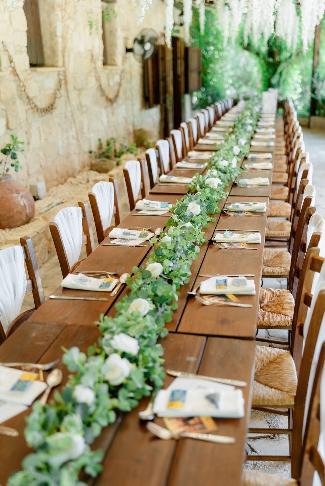 Hannah & Danial, long dinner tables under the wisteria at Vasilias Nikoklis Inn