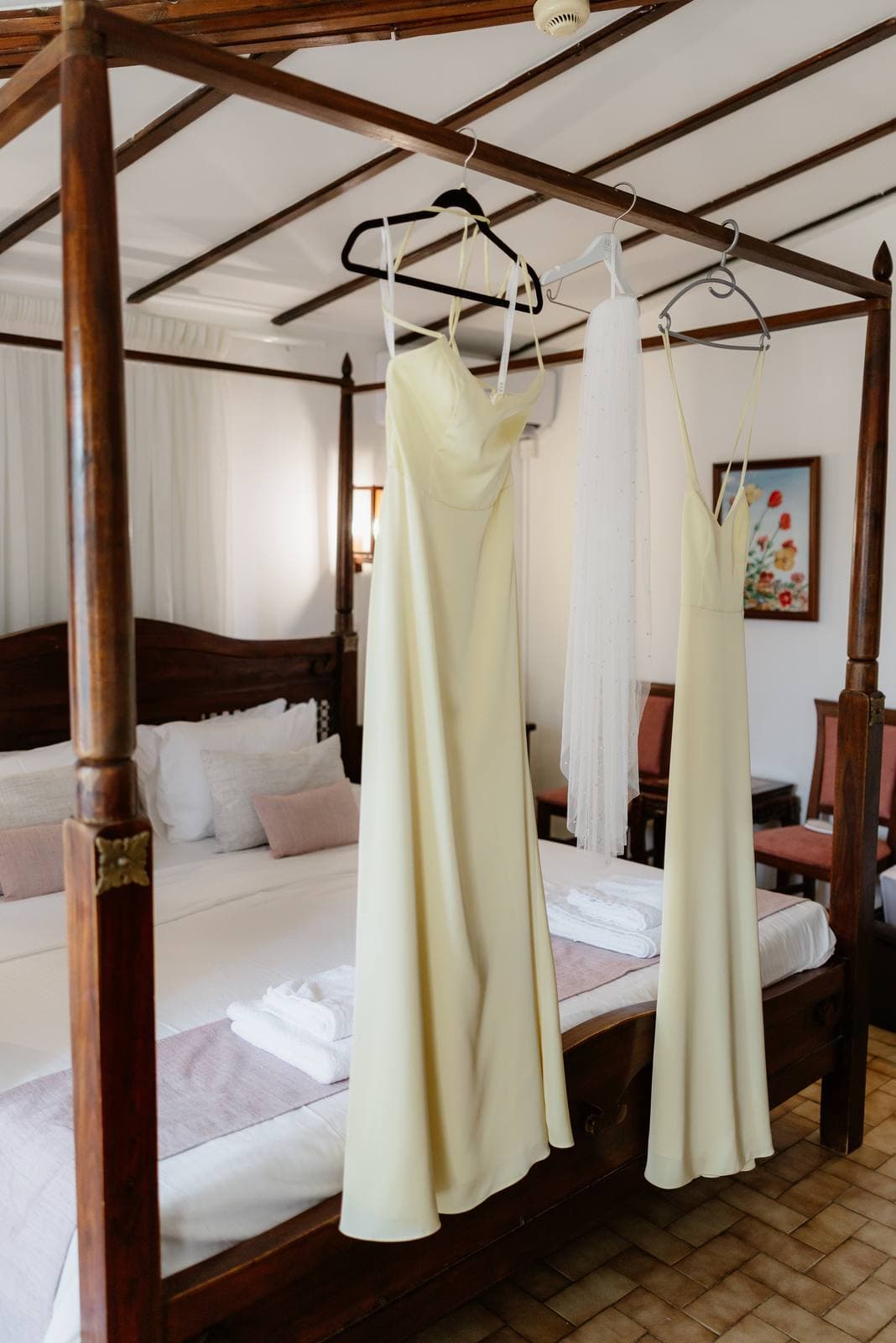 Hannah & Danial, bridesmaids' dresses hanging in the inn's four-poster room