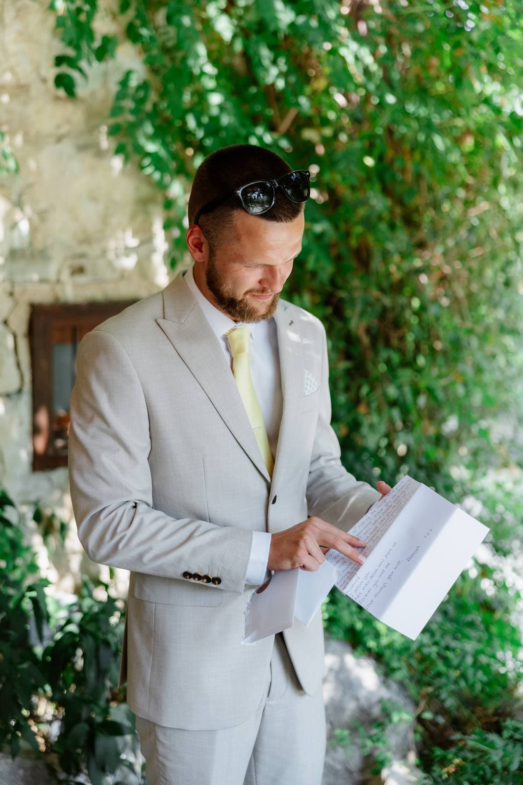 Hannah & Danial, the groom reading a letter from the bride