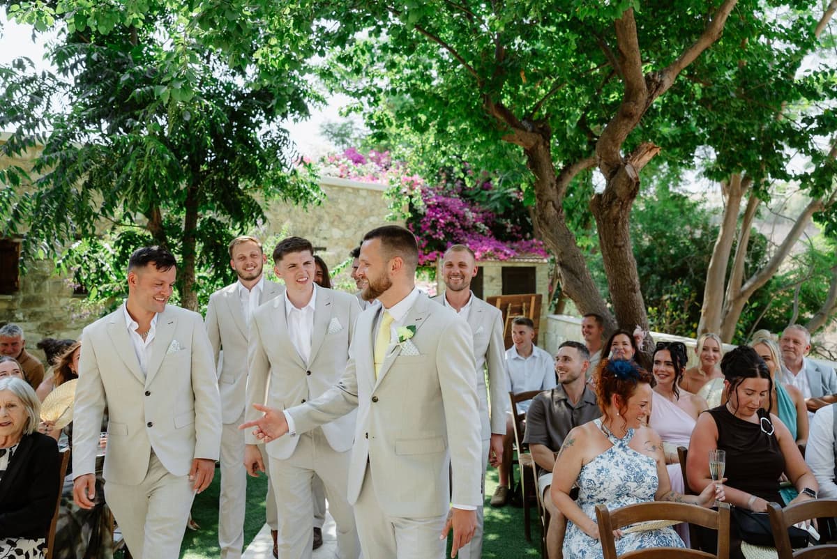 Hannah & Danial, the groom and groomsmen walking down the aisle