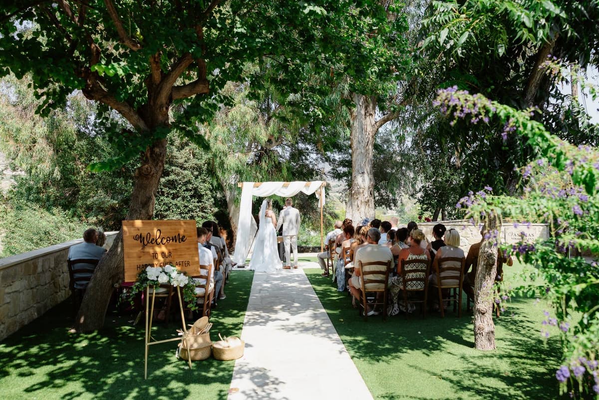 Hannah & Danial, the garden ceremony under the trees at Vasilias Nikoklis Inn