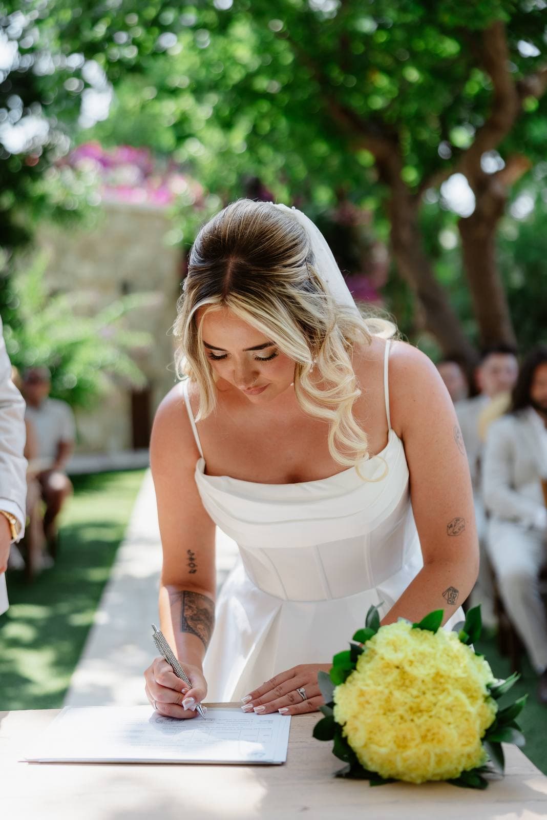 Hannah & Danial, the bride signing the register