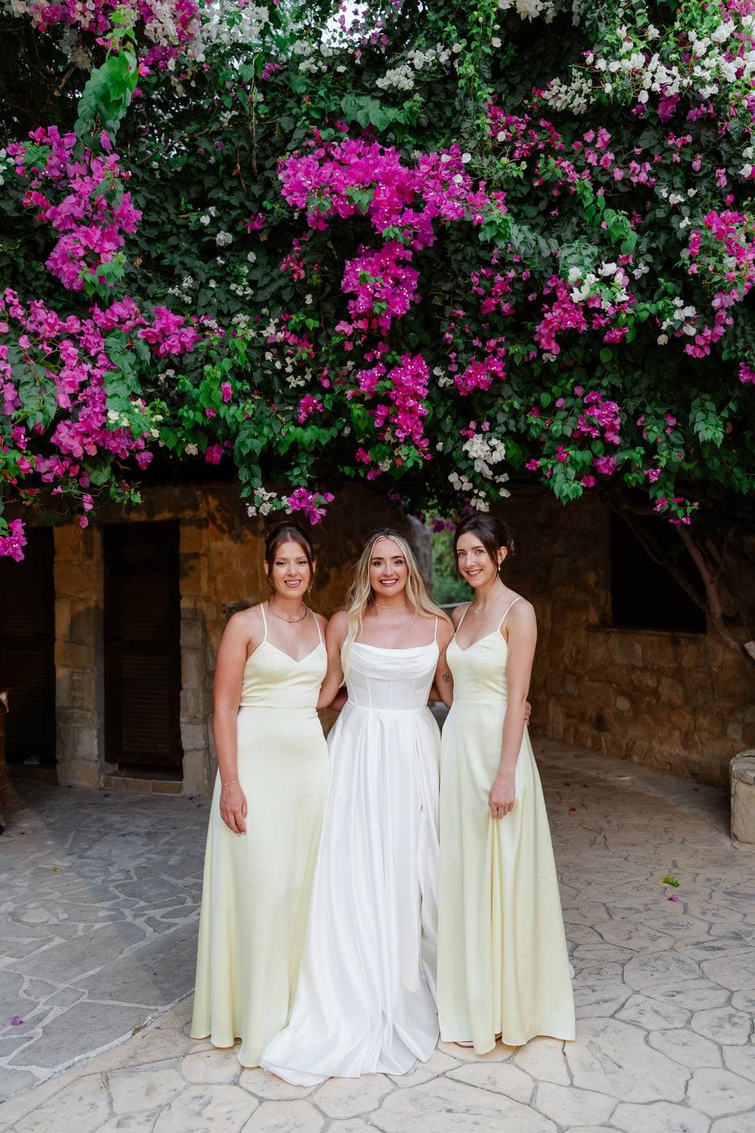 Hannah & Danial, the bride and bridesmaids under the bougainvillea