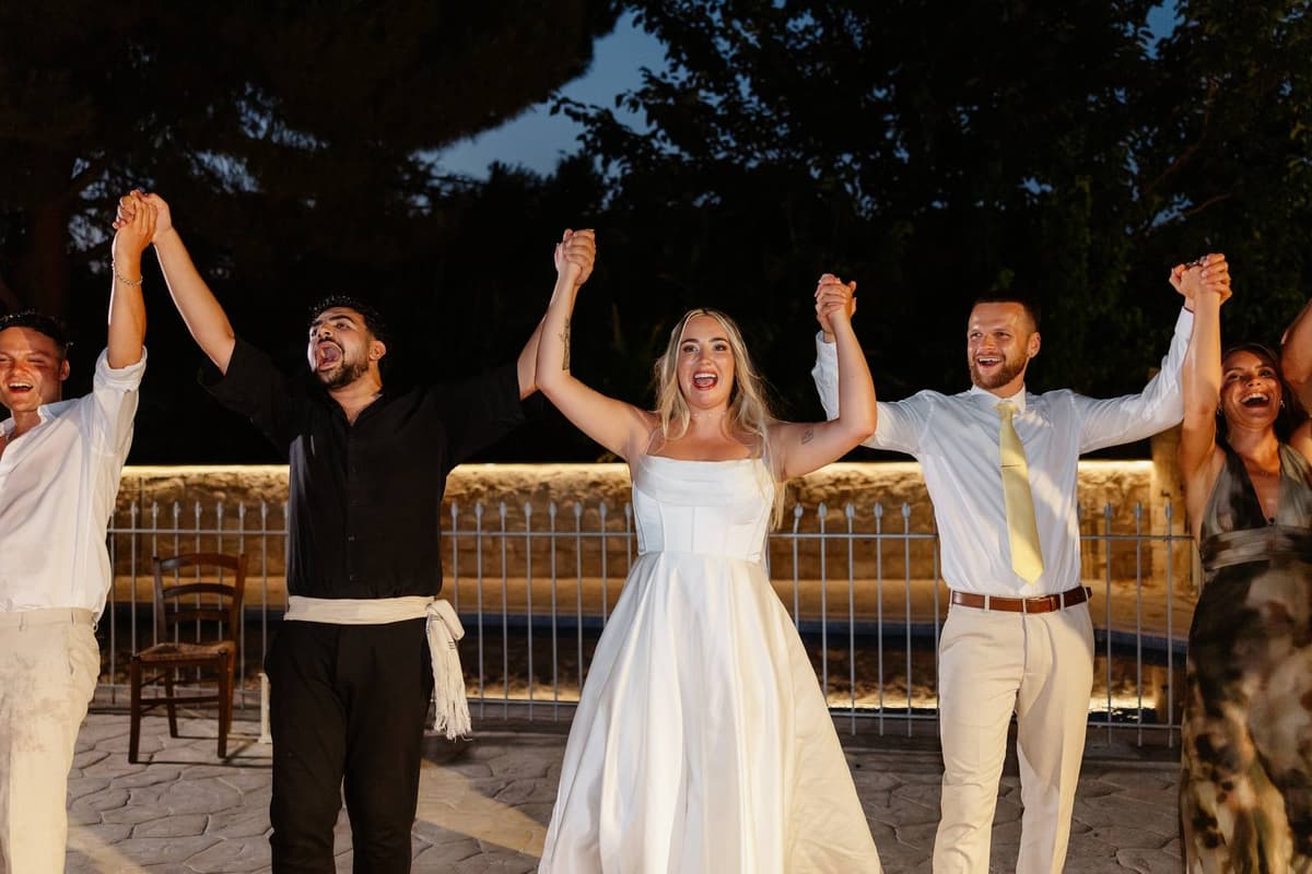 Hannah & Danial, the bride dancing with the Greek dancers