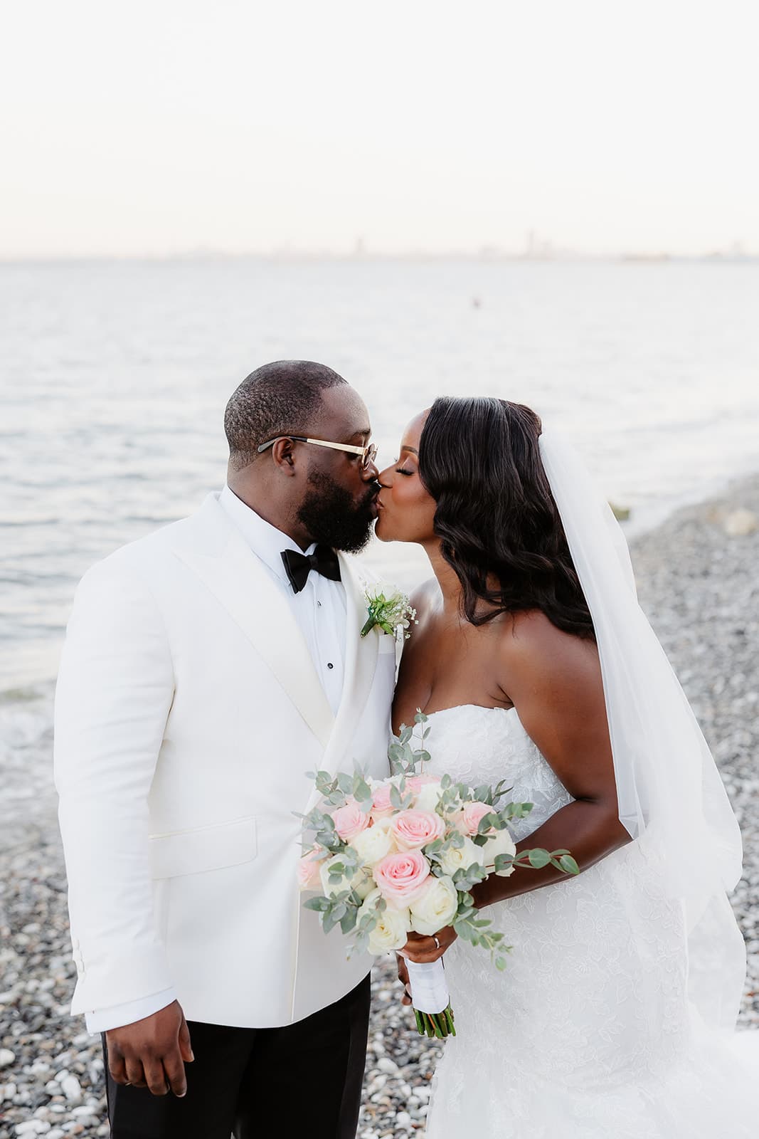 Bride and groom kissing on the beach