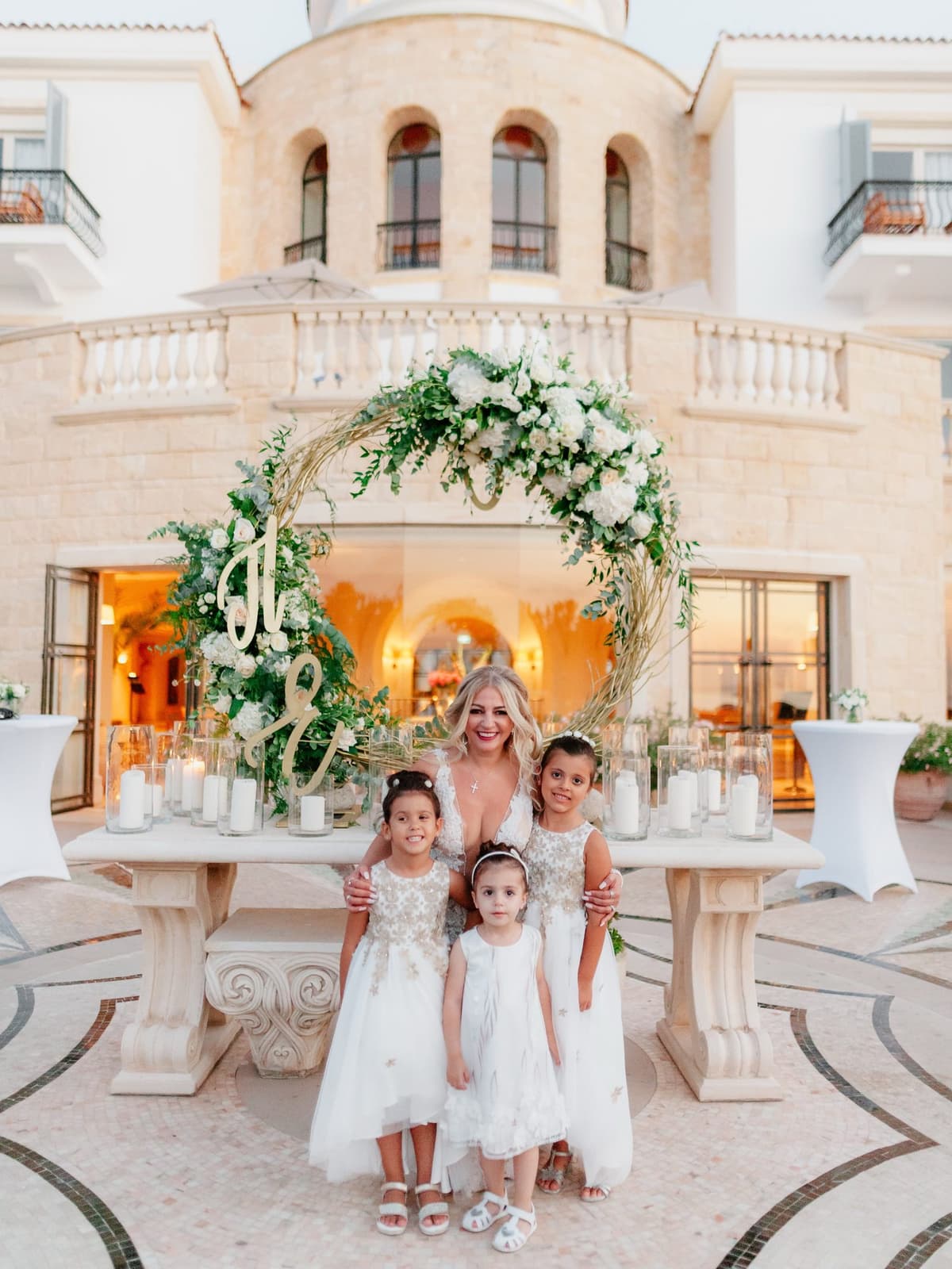 The flower girls by the floral arch at Anassa
