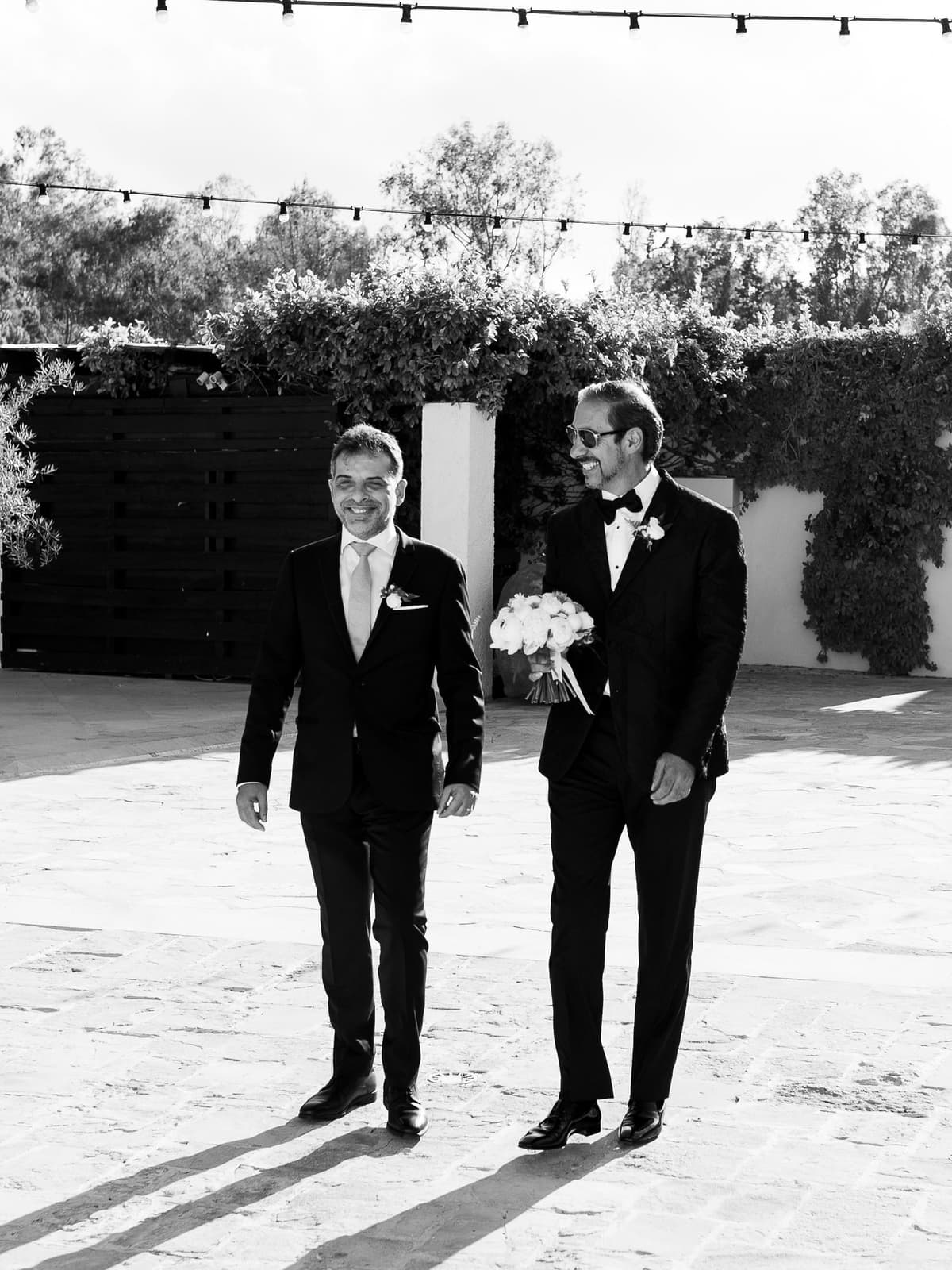 The groom walking with a guest