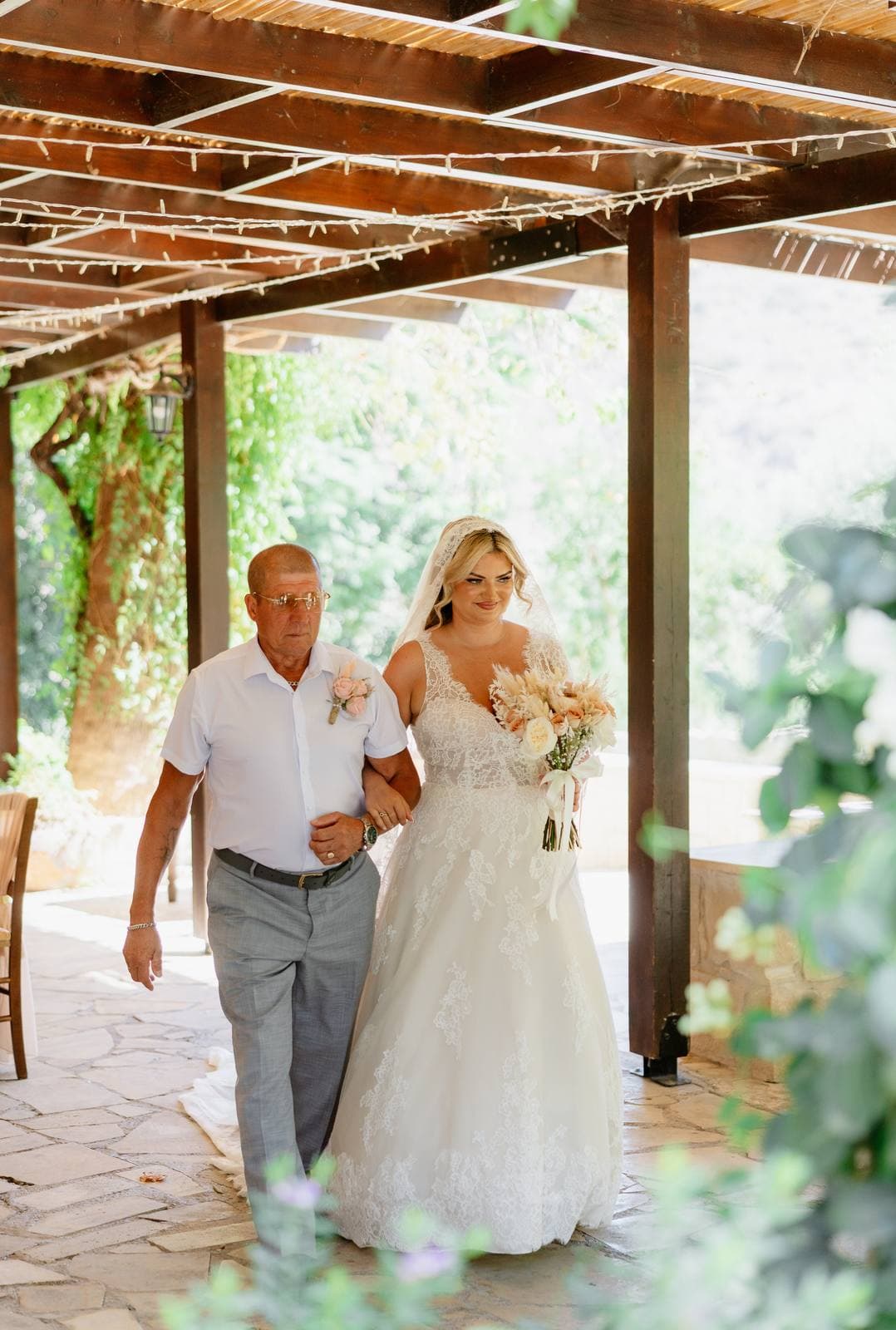 Rita & Andrej, the bride walking to the ceremony under the pergola