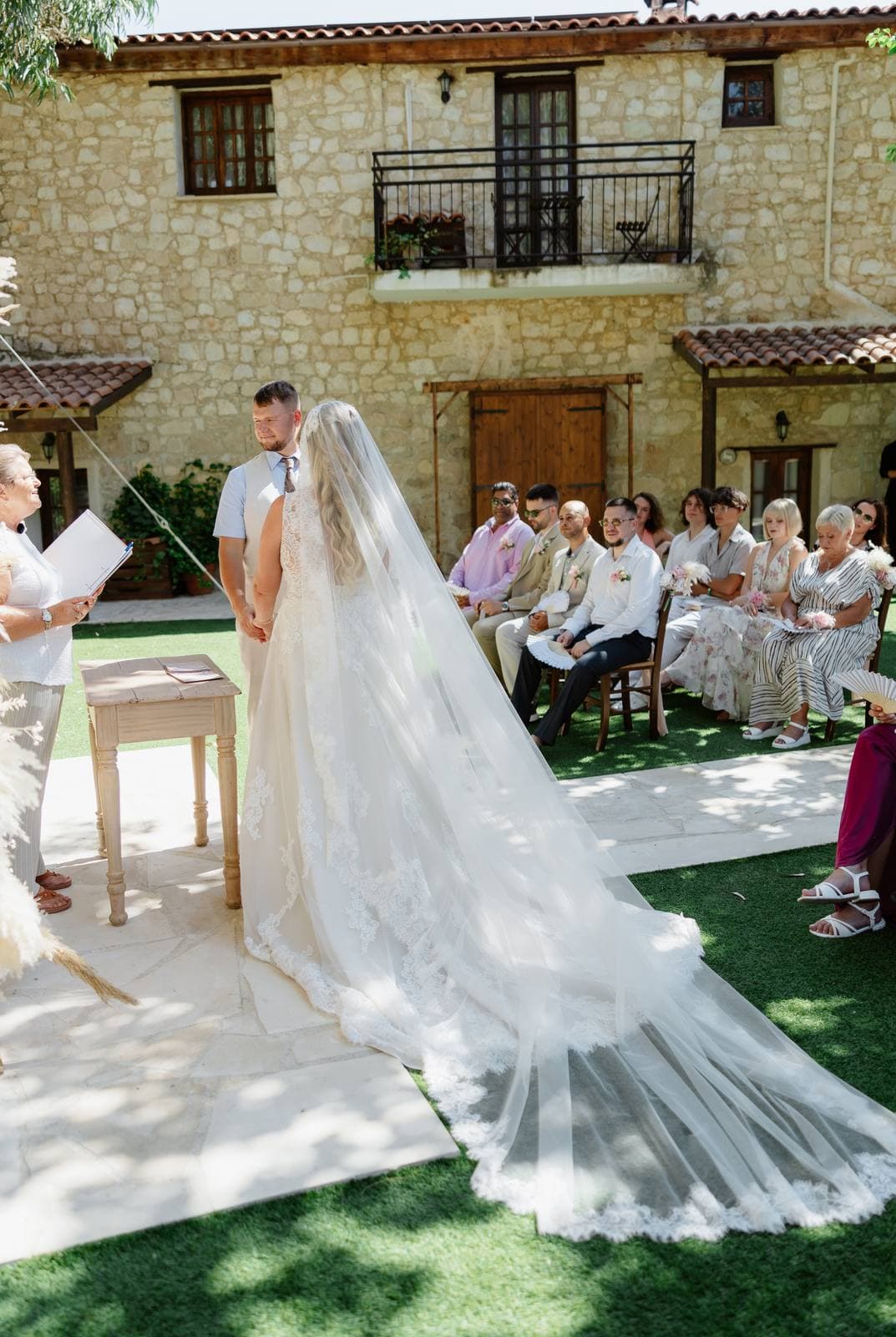 Rita & Andrej, the bride's veil across the lawn at the ceremony