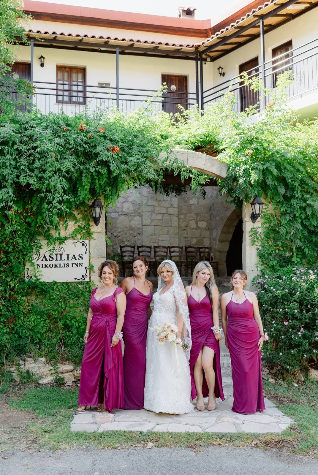 Rita & Andrej, the bride and bridesmaids at the entrance of Vasilias Nikoklis Inn