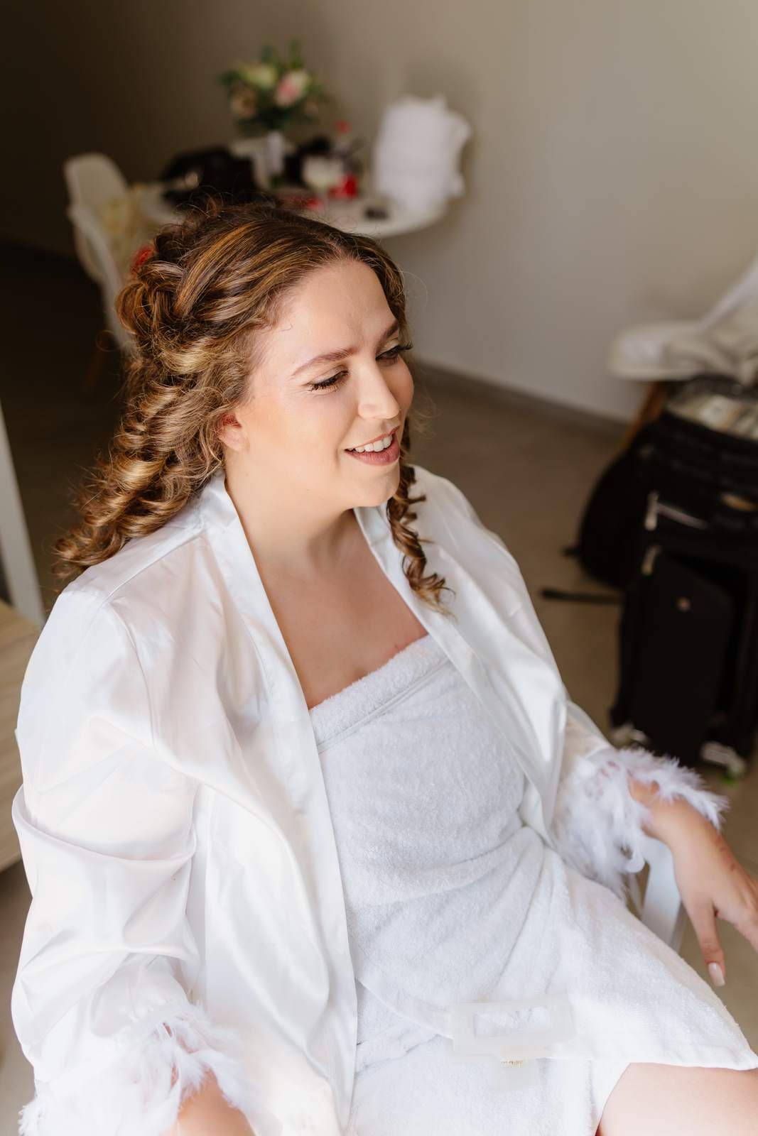 Sivan & Elon, the bride getting ready in her robe