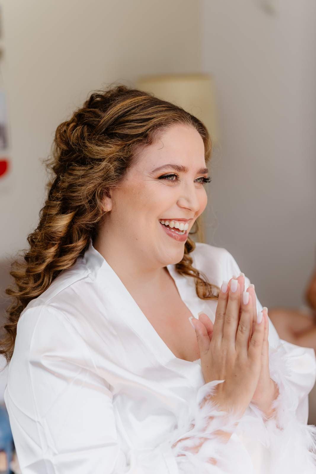 Sivan & Elon, the bride laughing as her hair is done