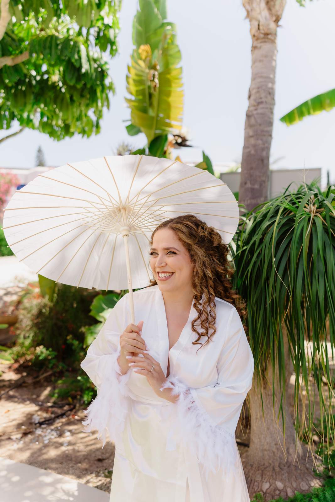 Sivan & Elon, the bride under a paper parasol