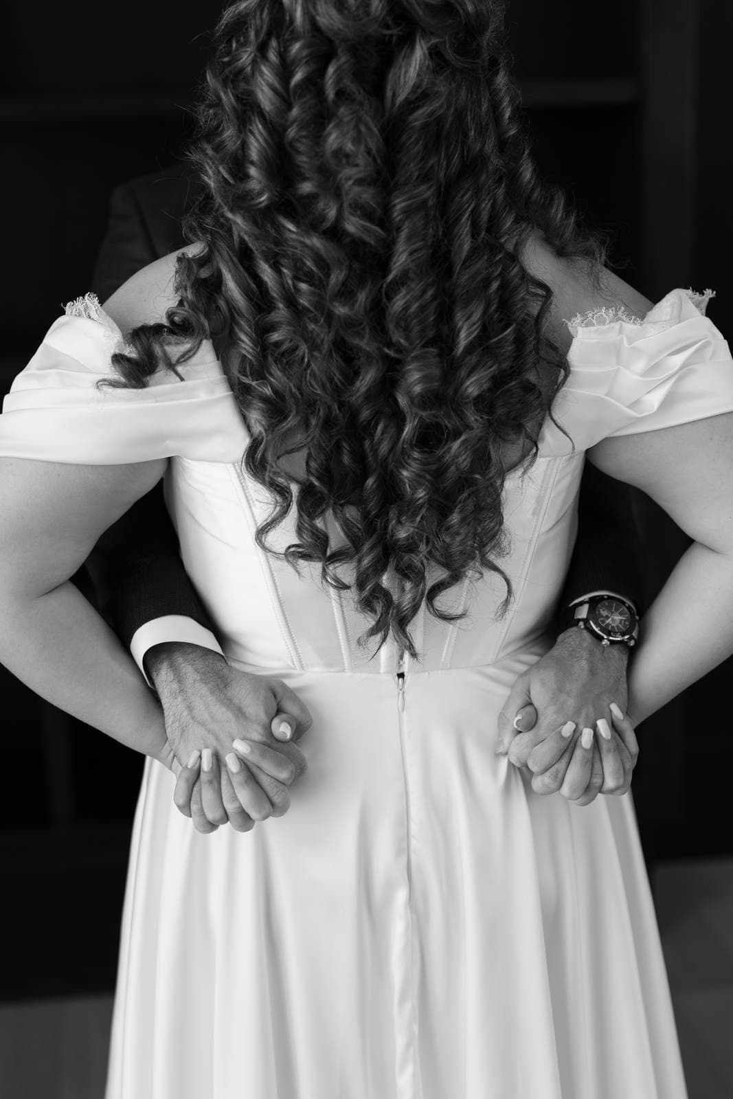 Sivan & Elon, his hands on her waist, in black and white
