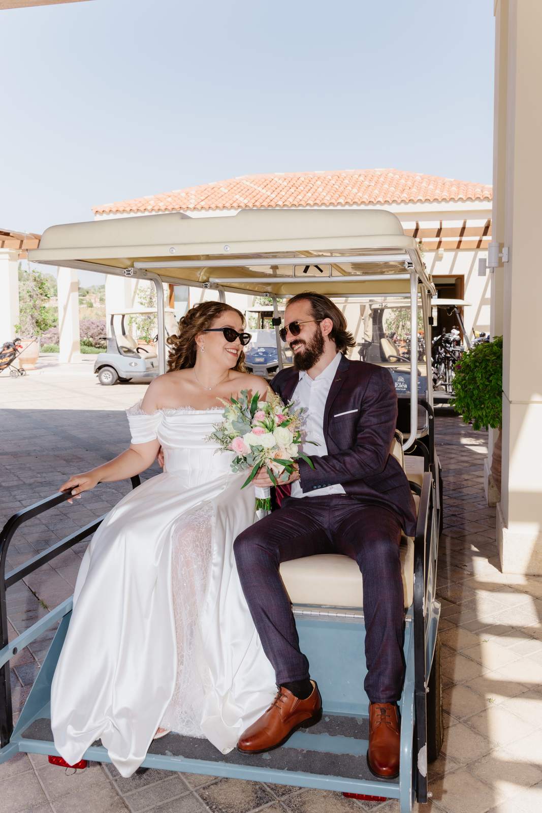 Sivan & Elon, riding in a golf cart
