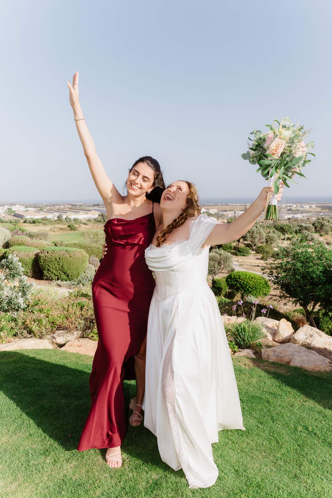 Sivan & Elon, the bride and a bridesmaid cheering