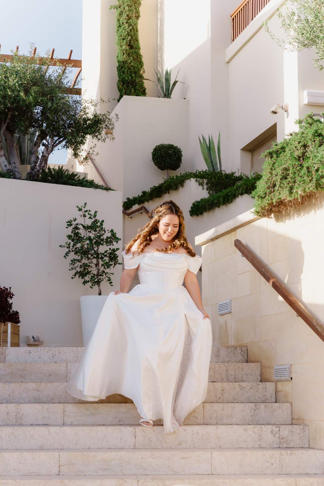 Sivan & Elon, the bride coming down the stairs to the ceremony