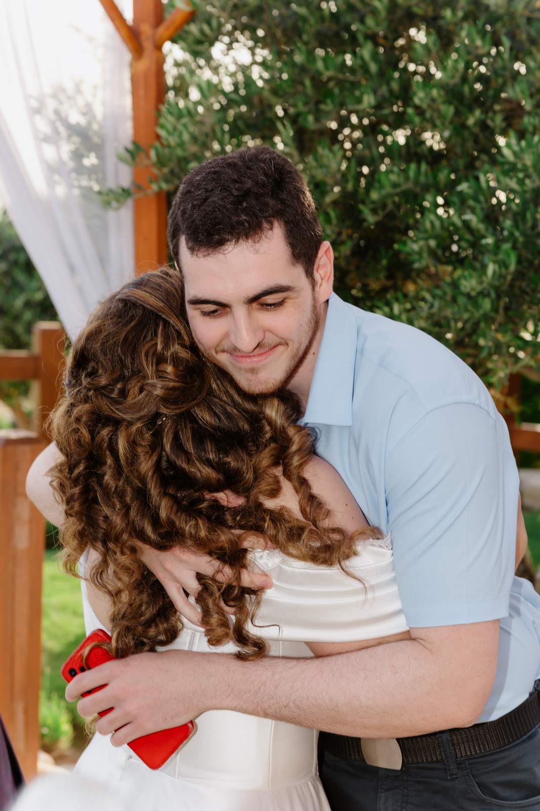 Sivan & Elon, a hug from a friend after the ceremony